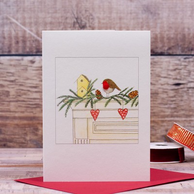 Robin on mantelpiece Christmas card