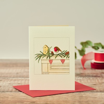 Robin on mantelpiece Christmas card