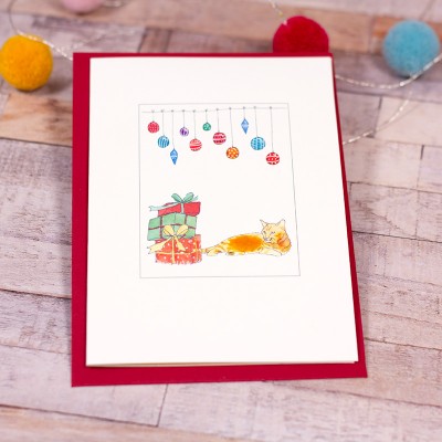 Ginger cat under baubles Christmas card