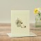 Siamese cat card next to large pot of flowers
