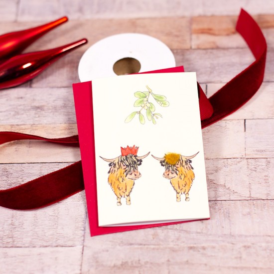Mini Highland cows under the Mistletoe Christmas card
